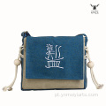 Bolsa crossbody de lona com símbolo primitivo Mei Yi Arts